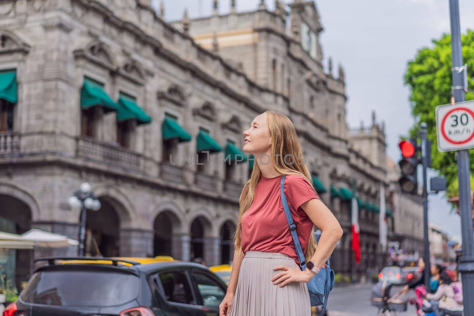 Female tourist walking through the colorful colonial streets of Puebla, Mexico. Travel, cultural exploration, and vibrant architecture concept.