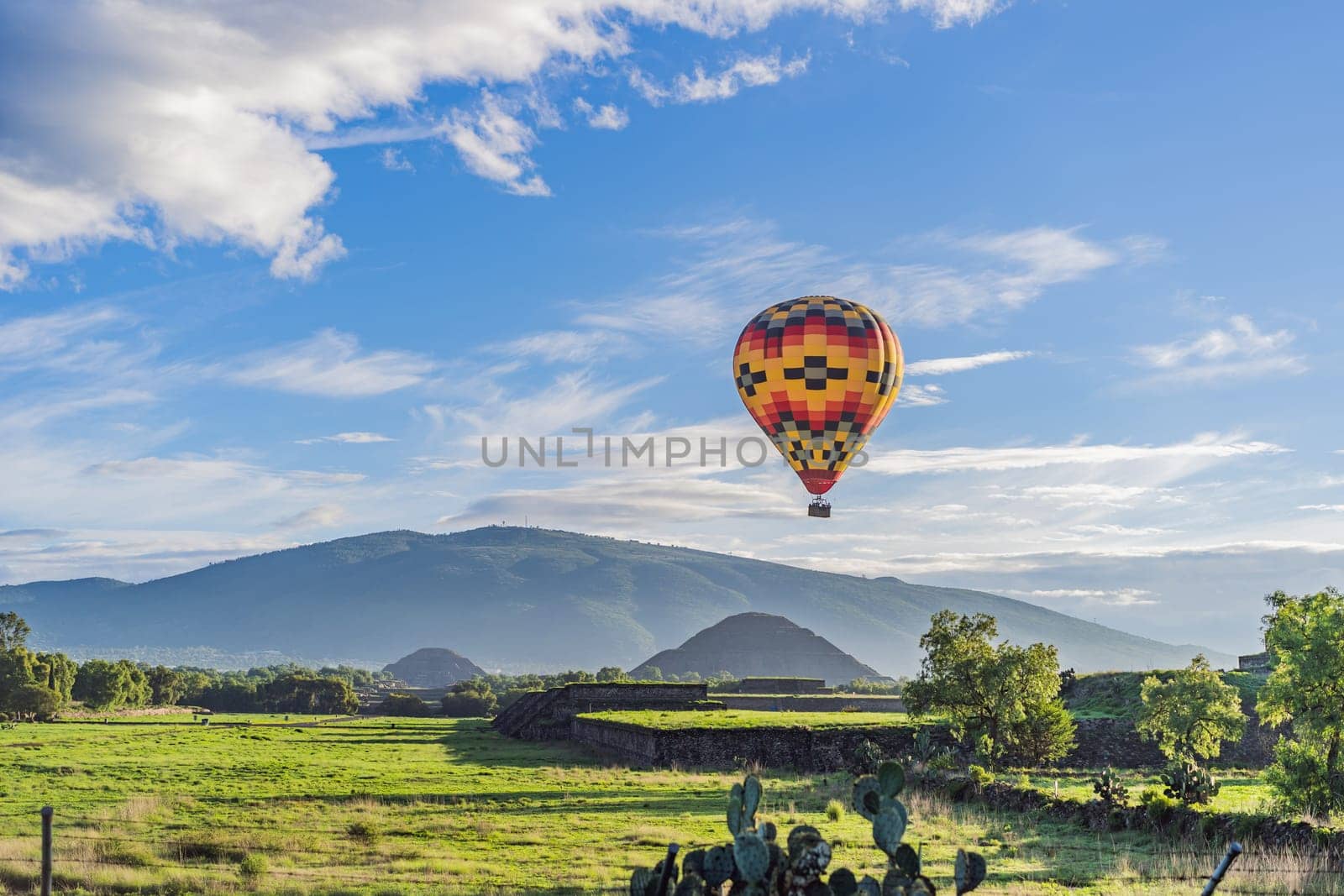 An aerial view of hot air balloons above the Teotihuacan pyramid. Adventure travel, cultural heritage, and aerial exploration concept.