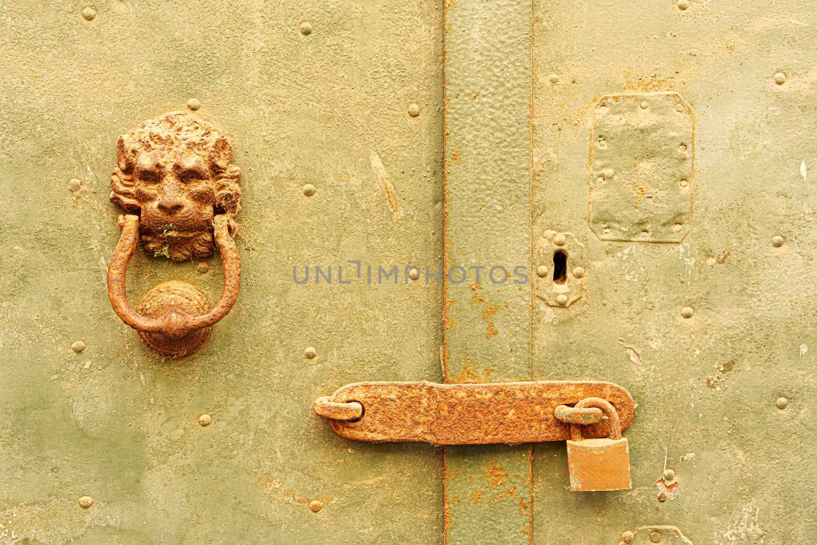 Detail of a knocker and a bolt on an old door. Bosa, Sardinia, Italy