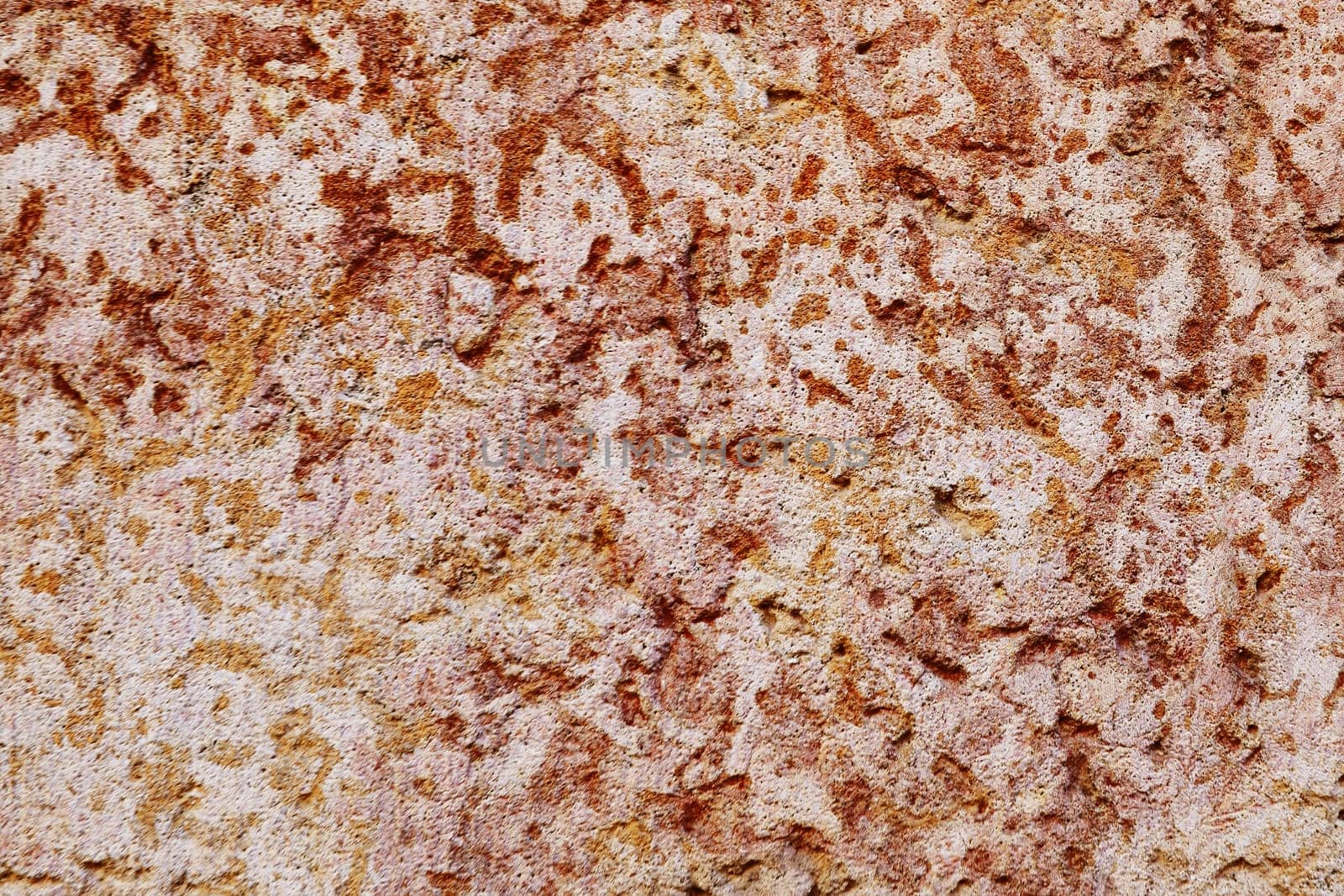 Granite texture. Natural red granite with a grainy pattern. Stone background. Solid rough surface of rock.