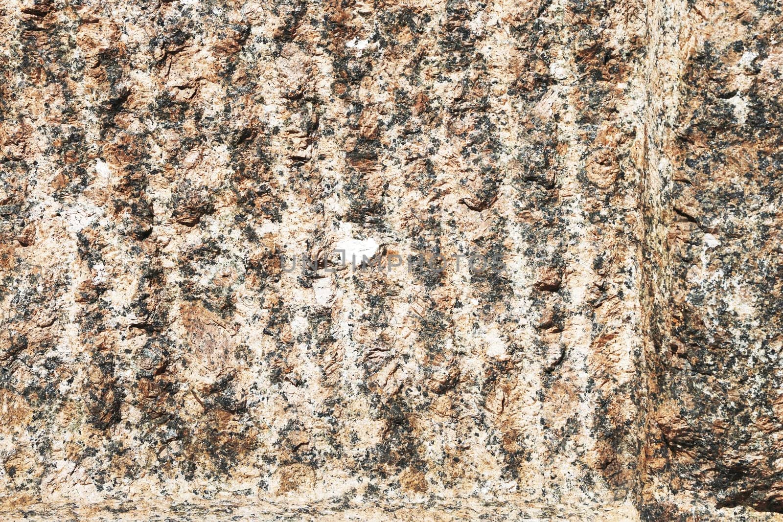 Granite texture. Natural red granite with a grainy pattern. Stone background. Solid rough surface of rock.