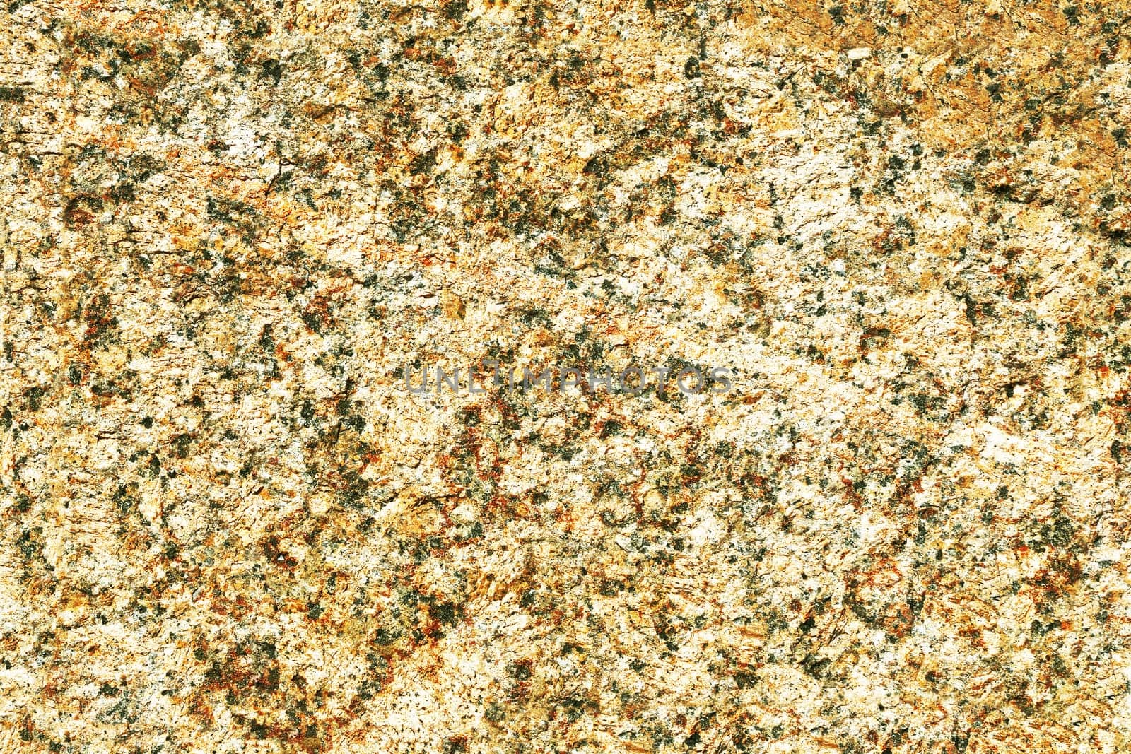 The surface of the stone, granite wall is brown.