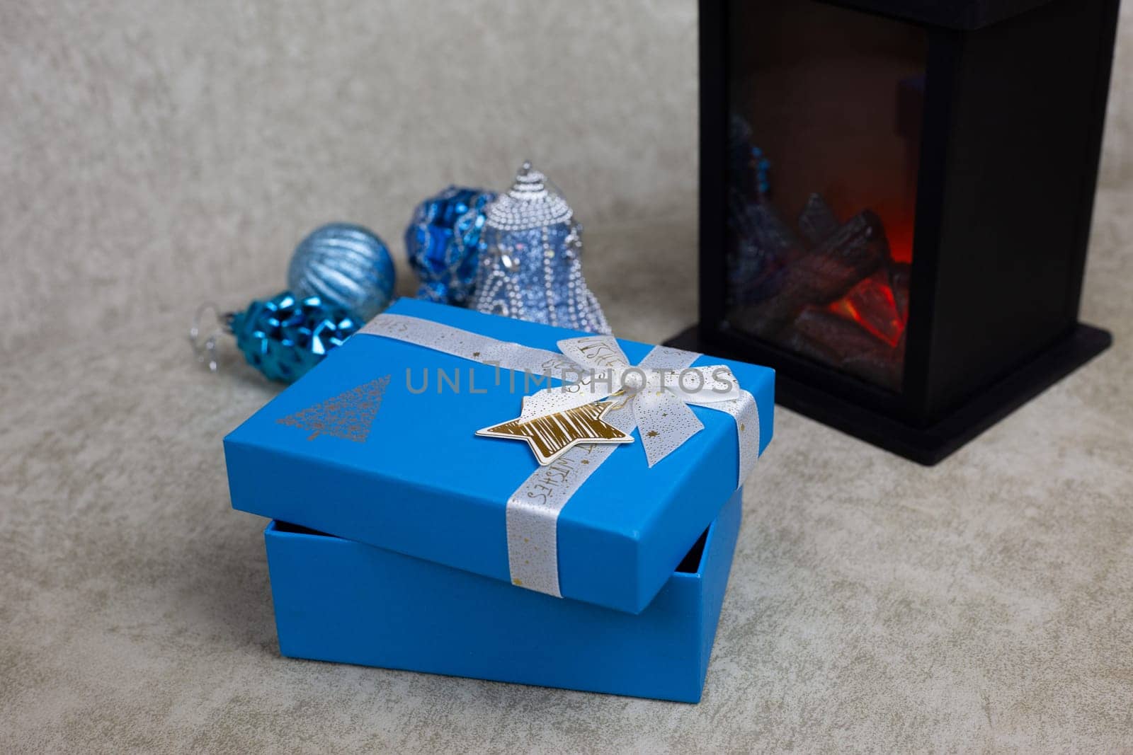 Slightly open gift box for New Year holiday on light background, place for gifts for Christmas. Decorated gift wrapping for New Year present