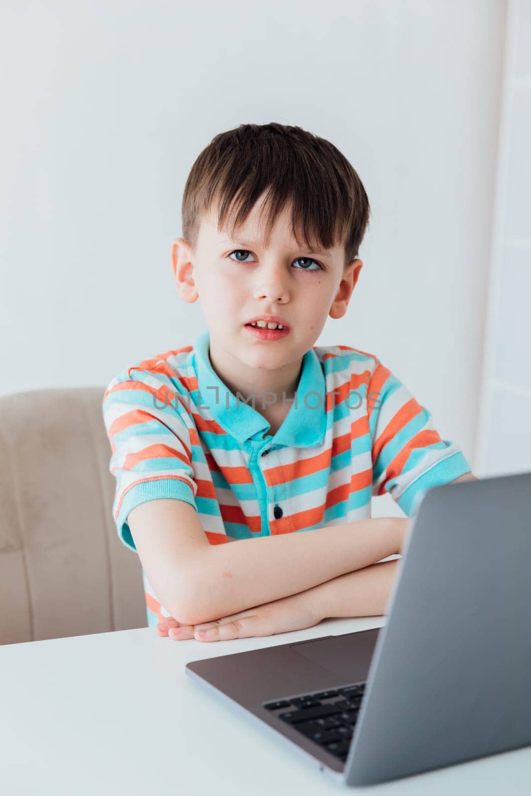 Schoolboy At Table With Laptop