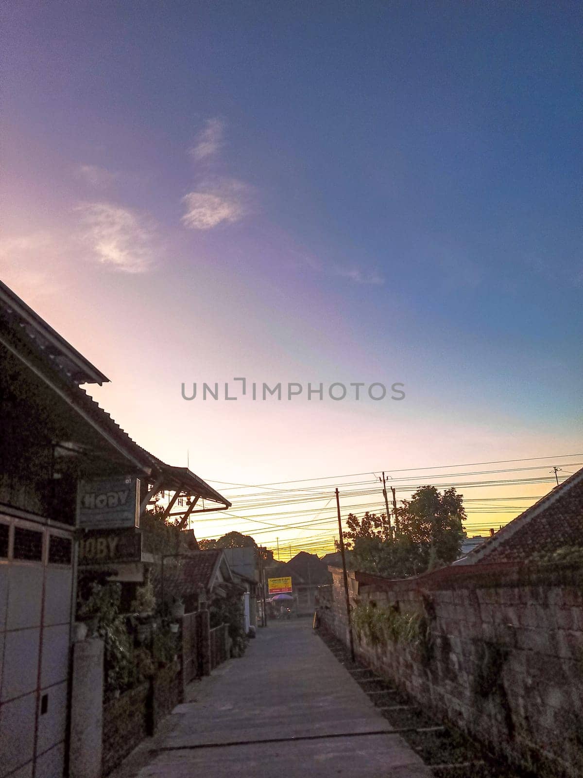 Scenic morning view on a countryside. The sun rises and makes a glowing blue white light
