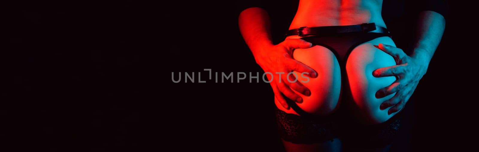 male hands passionately touch the sexy bum of a naked girl. Panoramic wide horizontal photo for banner head cover