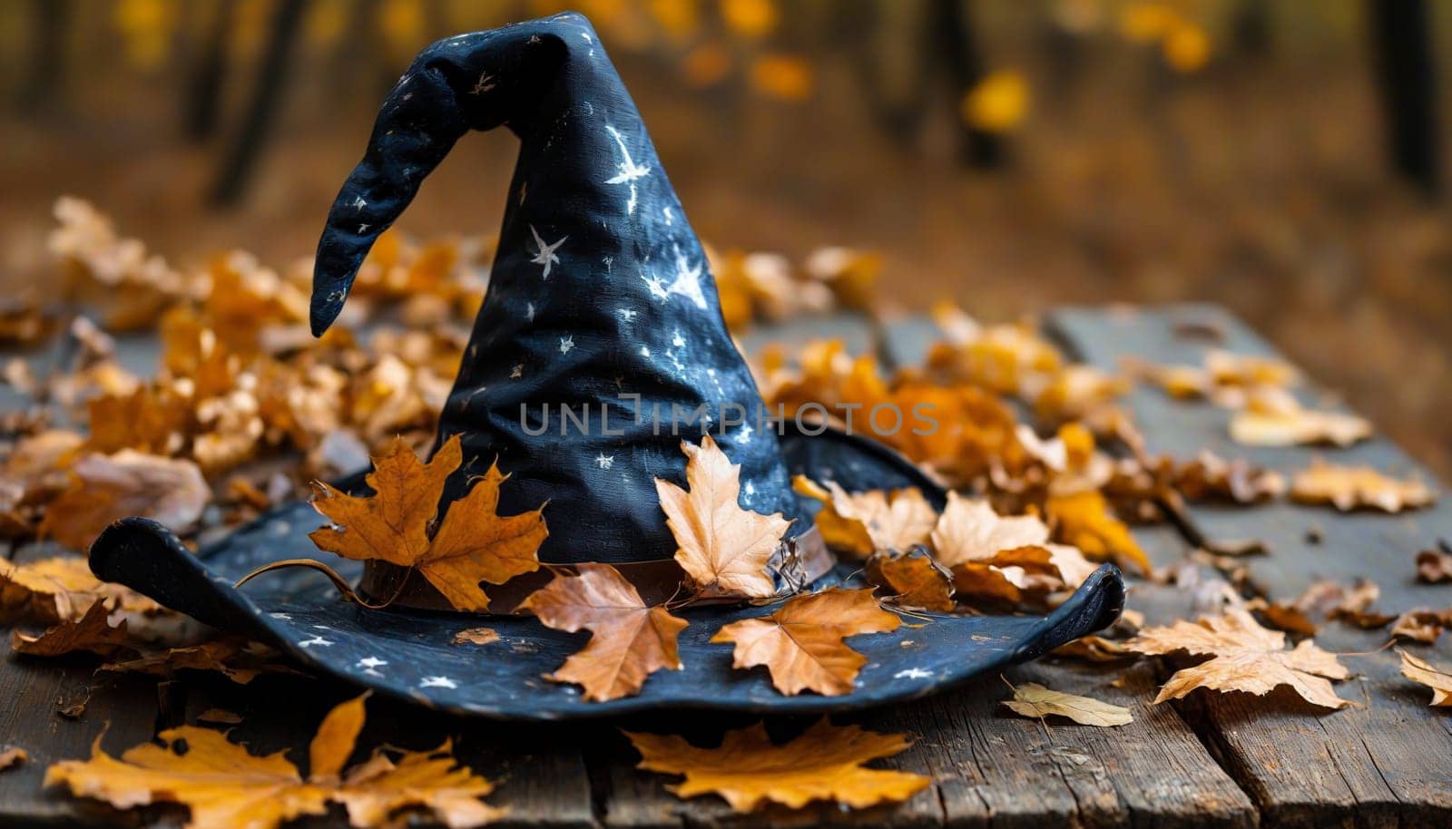 A whimsical witch's hat rests among colorful autumn leaves and tiny pumpkins on a weathered wooden surface, evoking the magic and warmth of fall festivities.