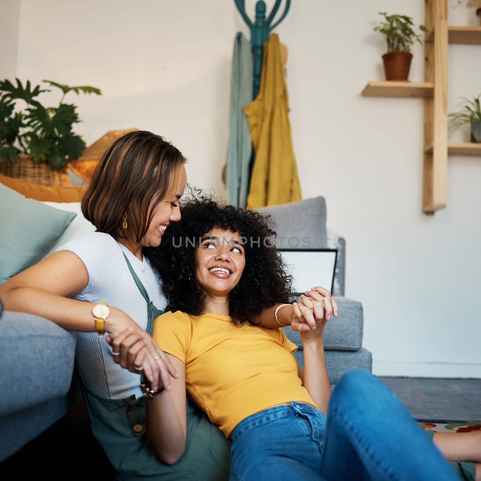Lesbian, couple and relax on couch in communication at home for support, trust and partnership. Happy lgbt woman, living room or smile for identity or equality love in house, commitment or together.