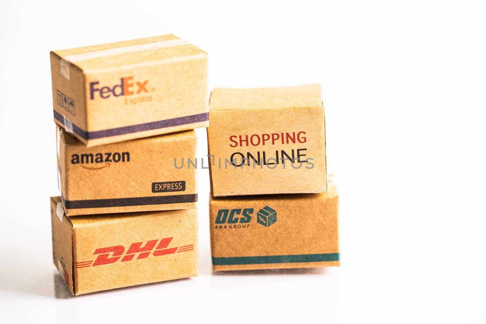 Bangkok, Thailand September 26, 2022 Shopping cart with DHL Amazon and FedEx express packing box, import export online exchange investment business. by pamai