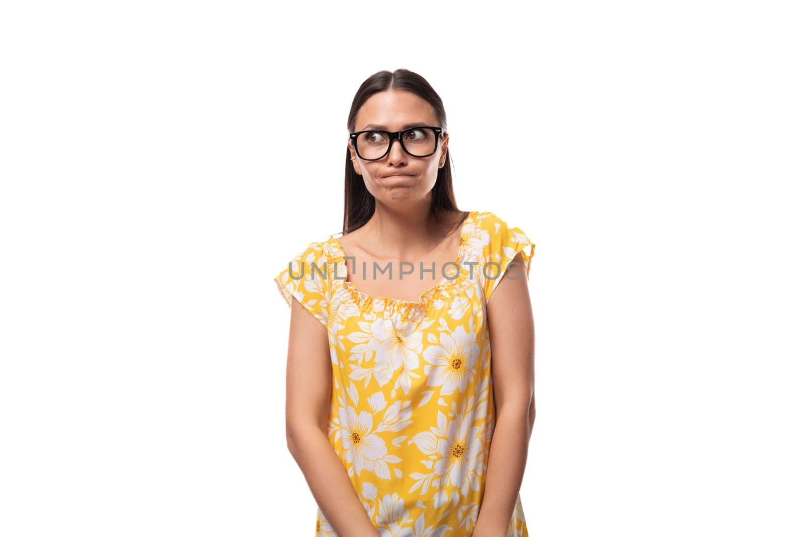 young caucasian woman with vision glasses in perplexity on a white background by TRMK