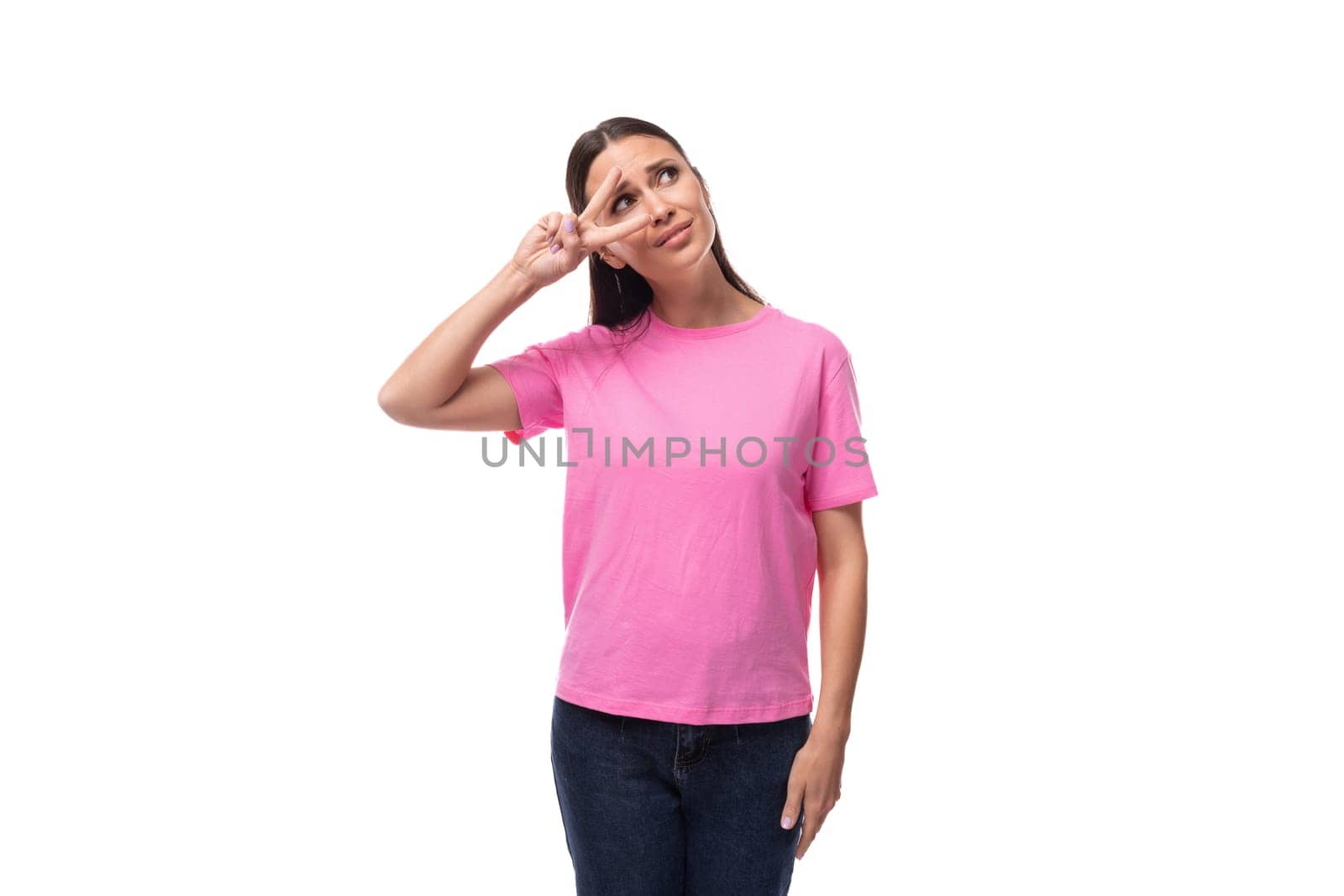 young charismatic good-looking woman with black hair is wearing a pink t-shirt on a white background with copy space.