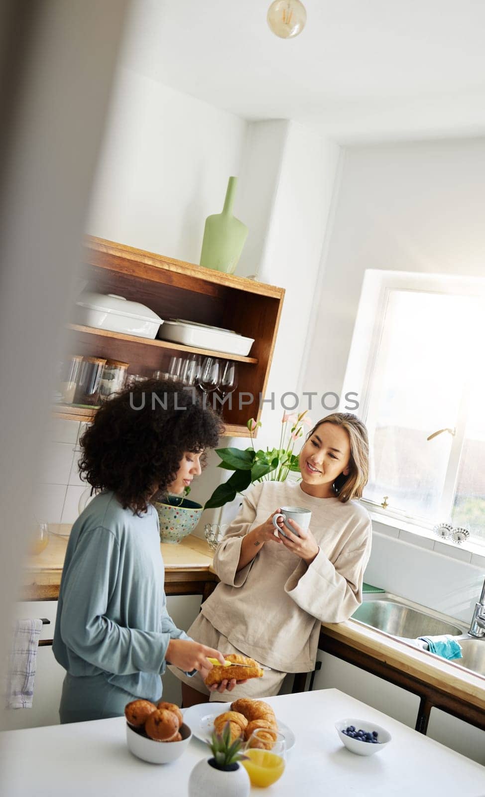 Lesbian, women and couple with love, breakfast and romance with conversation, marriage and bonding. Lgbtq, girls and queer people in a kitchen, home and relationship with trust, speaking and support by YuriArcurs