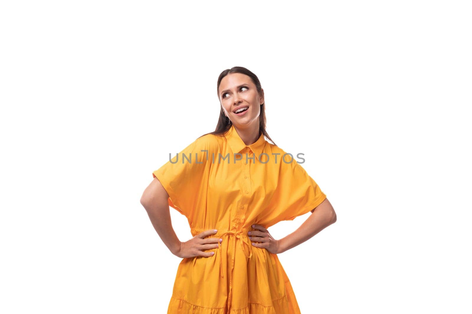 young caucasian brunette woman with long hair dressed in yellow summer dress on vacation by TRMK