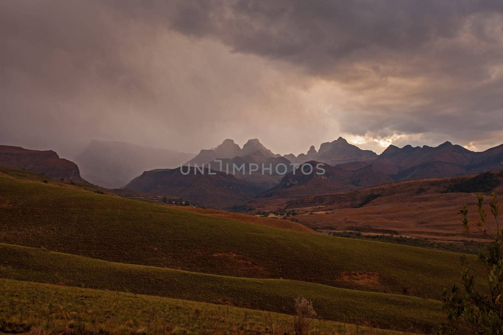 A stormy sunset at Cathedral Peak in the Drakensberg Mountains. KwaZulu-Natal Province, South Africa