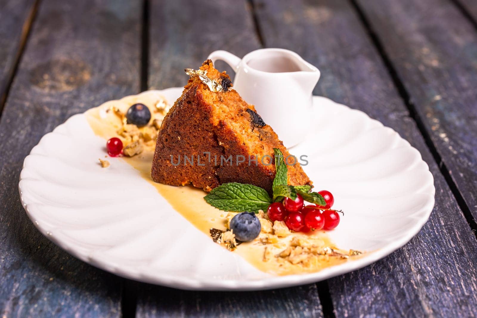 a piece of sponge cake on a plate. dessert in the restaurant photo for the menu by Pukhovskiy