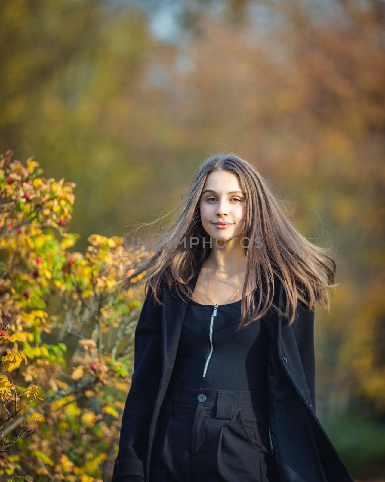 Happy girl spinning in the autumn park