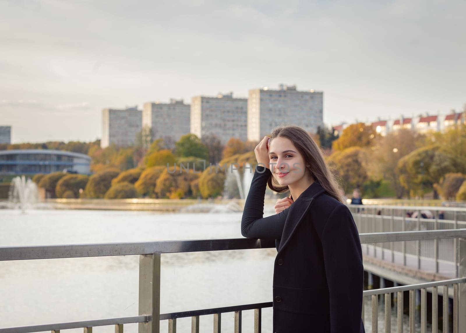 Portrait of a girl on a bridge near a pond in a city park. by Yurich32