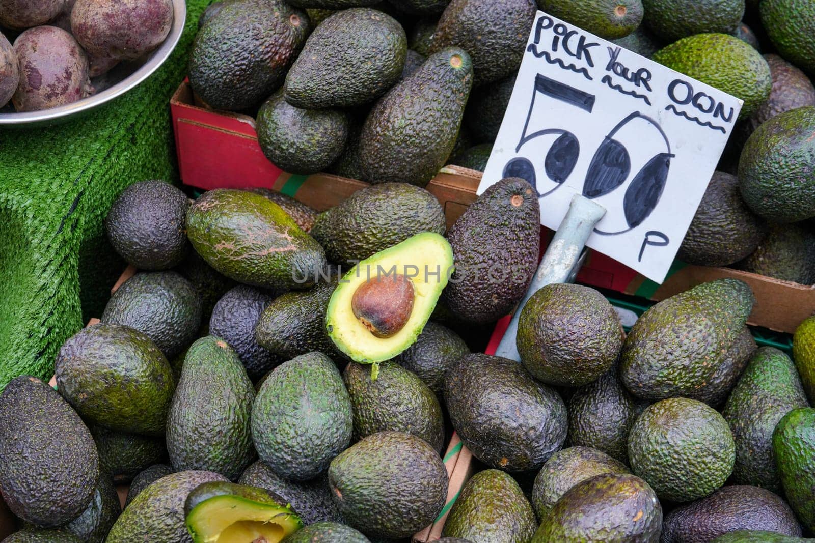 Avocados displayed on food market at Lewisham, London by Ivanko