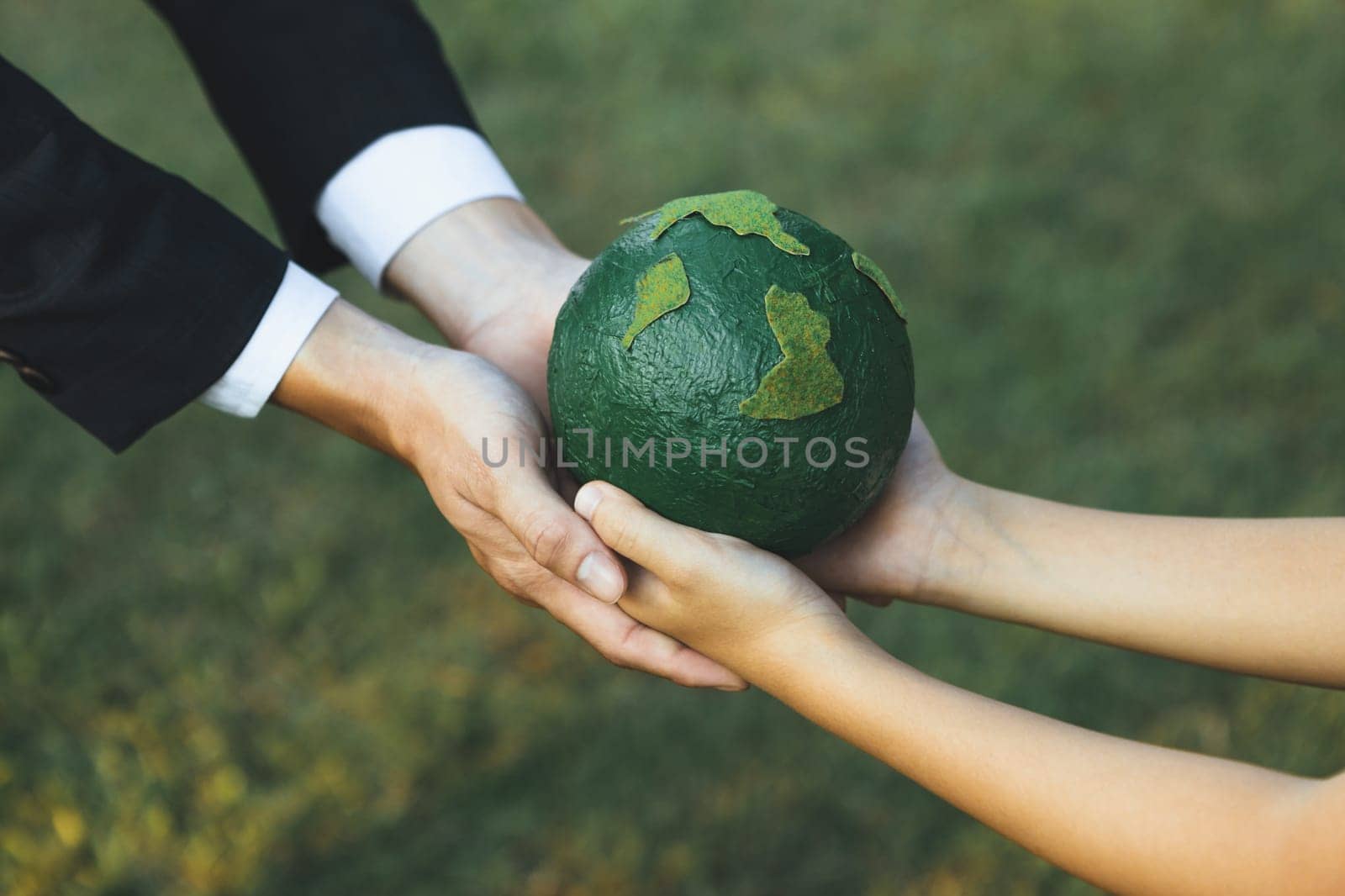Businessman hand giving Earth globe to little boy as Earth day concept. Gyre by biancoblue
