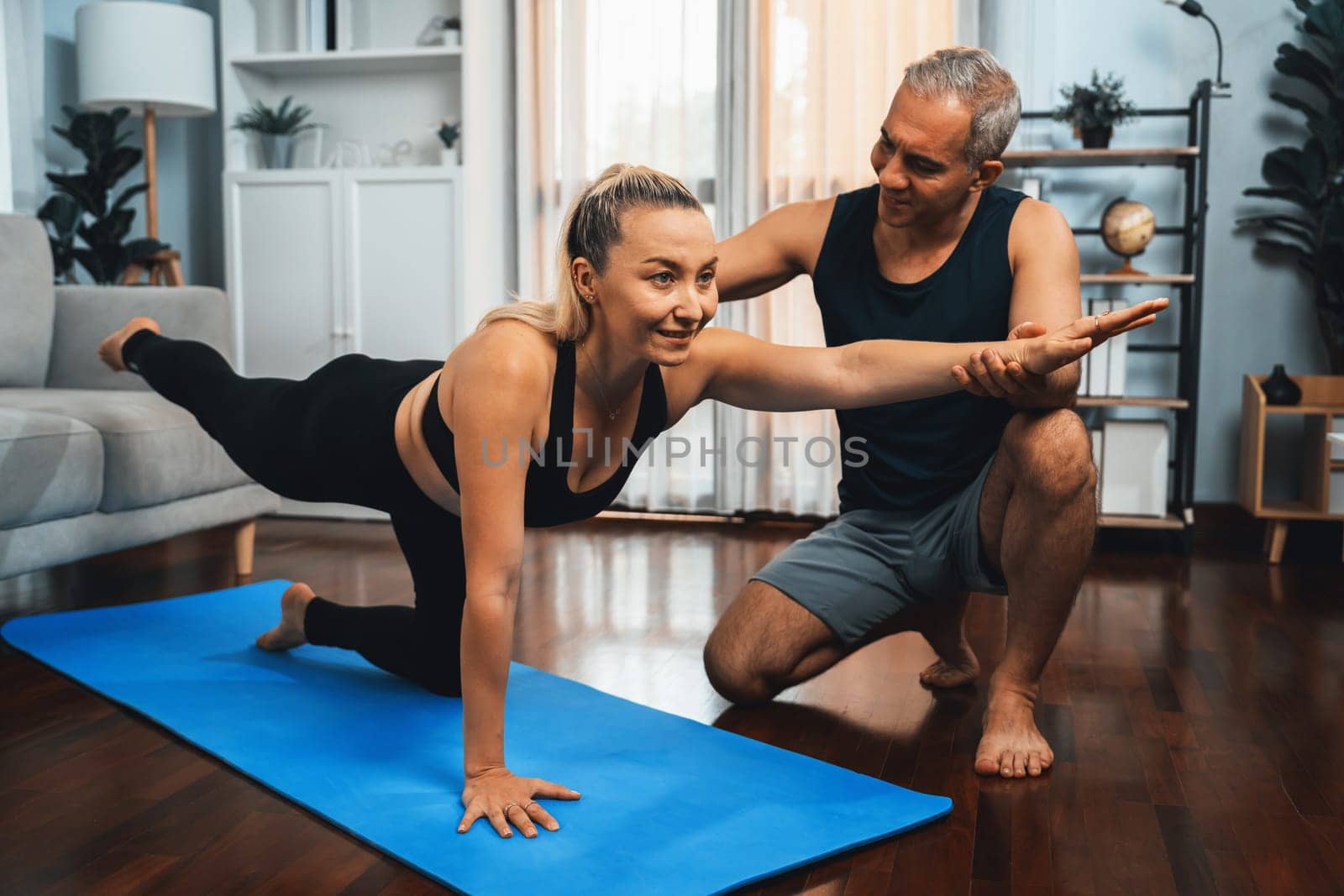 Happy active senior couple in sportswear doing yoga. Clout by biancoblue