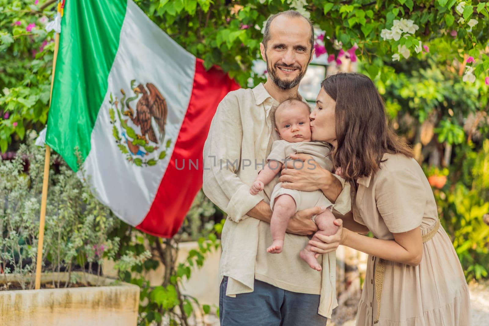 Immigrant family in front of the Mexican flag. New Mexicans. Childbirth in Mexico by galitskaya