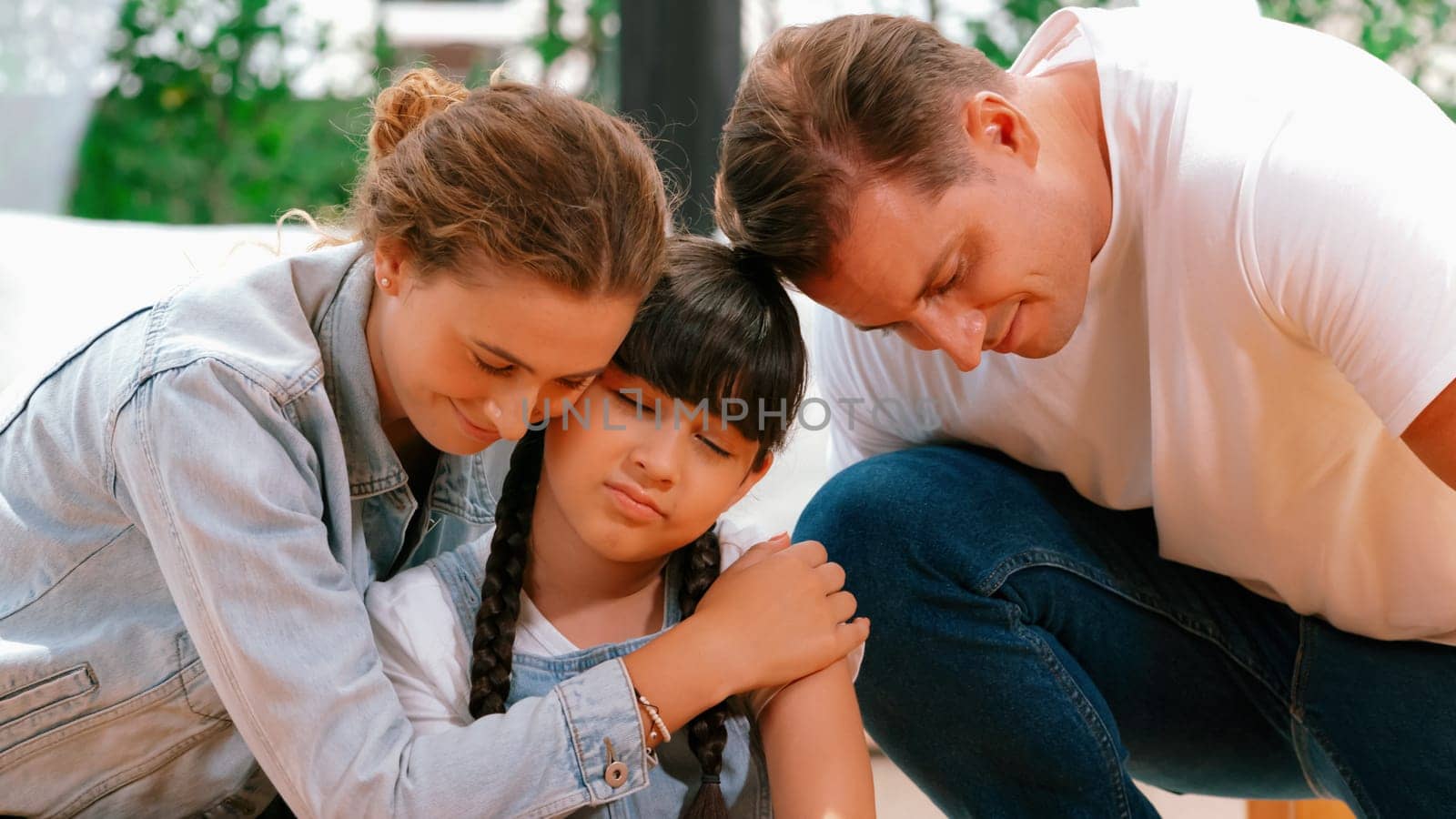 Parents comforting their daughter with loving hug, helping her feel secure and protected from fear, rest her head on shoulder and sadness melts away. Family love and child care Panorama. Synchronos