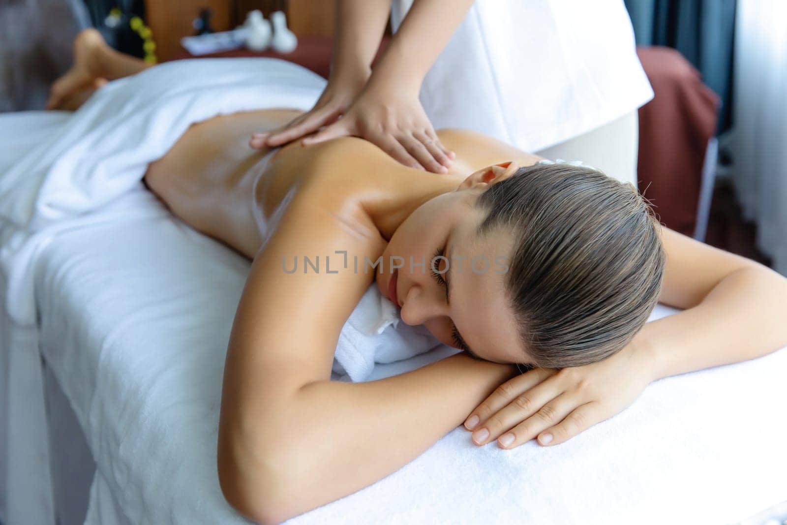 Caucasian woman customer enjoying relaxing anti-stress massage. Quiescent by biancoblue