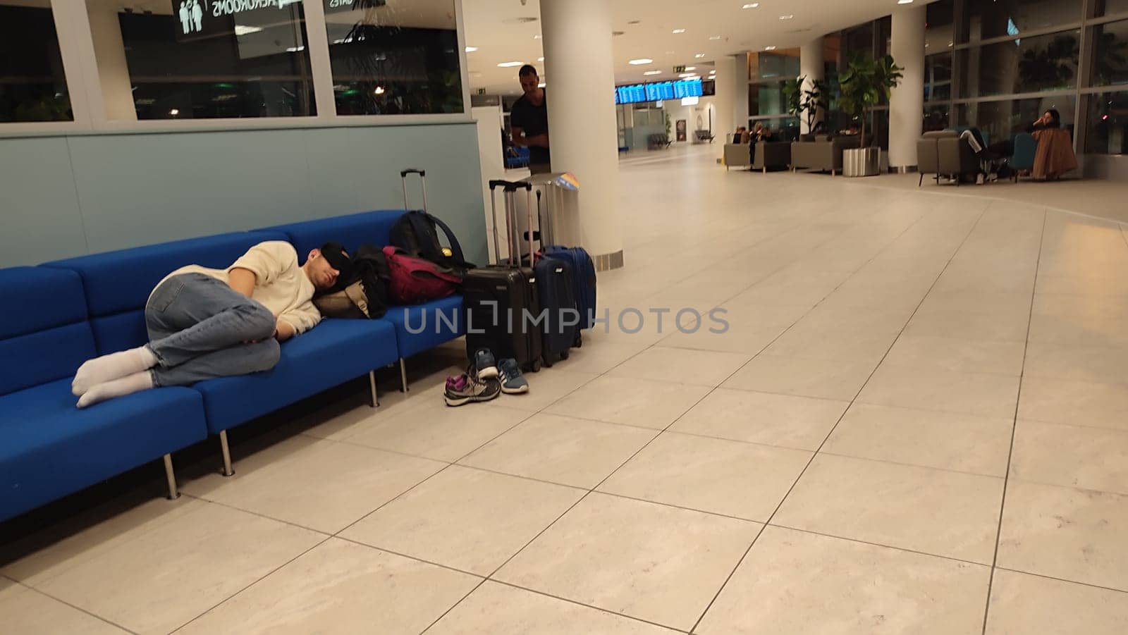 October 26, 2024 Prague Czech Republic, Vaclav Havel Airport, people tourists relax in chairs in the lobby waiting for a flight. High quality photo