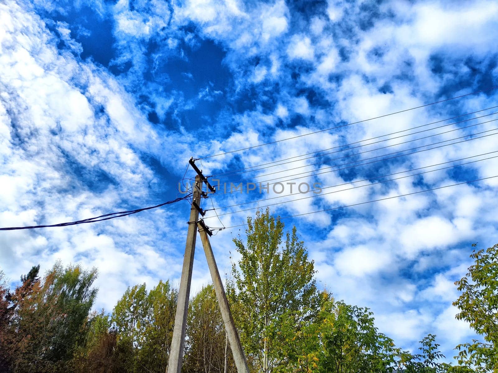 Old pole with wires against the sky. Electric transmission line, Eco-friendly energy