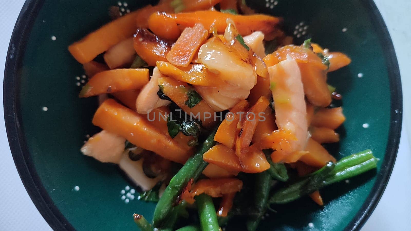 vegetables and fish, healthy food in a green plate. High quality photo