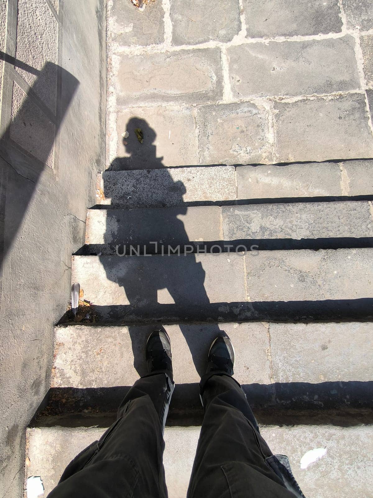 shadow of a man on marble stone steps 18 August 2024 Tbilisi Georgia. High quality photo