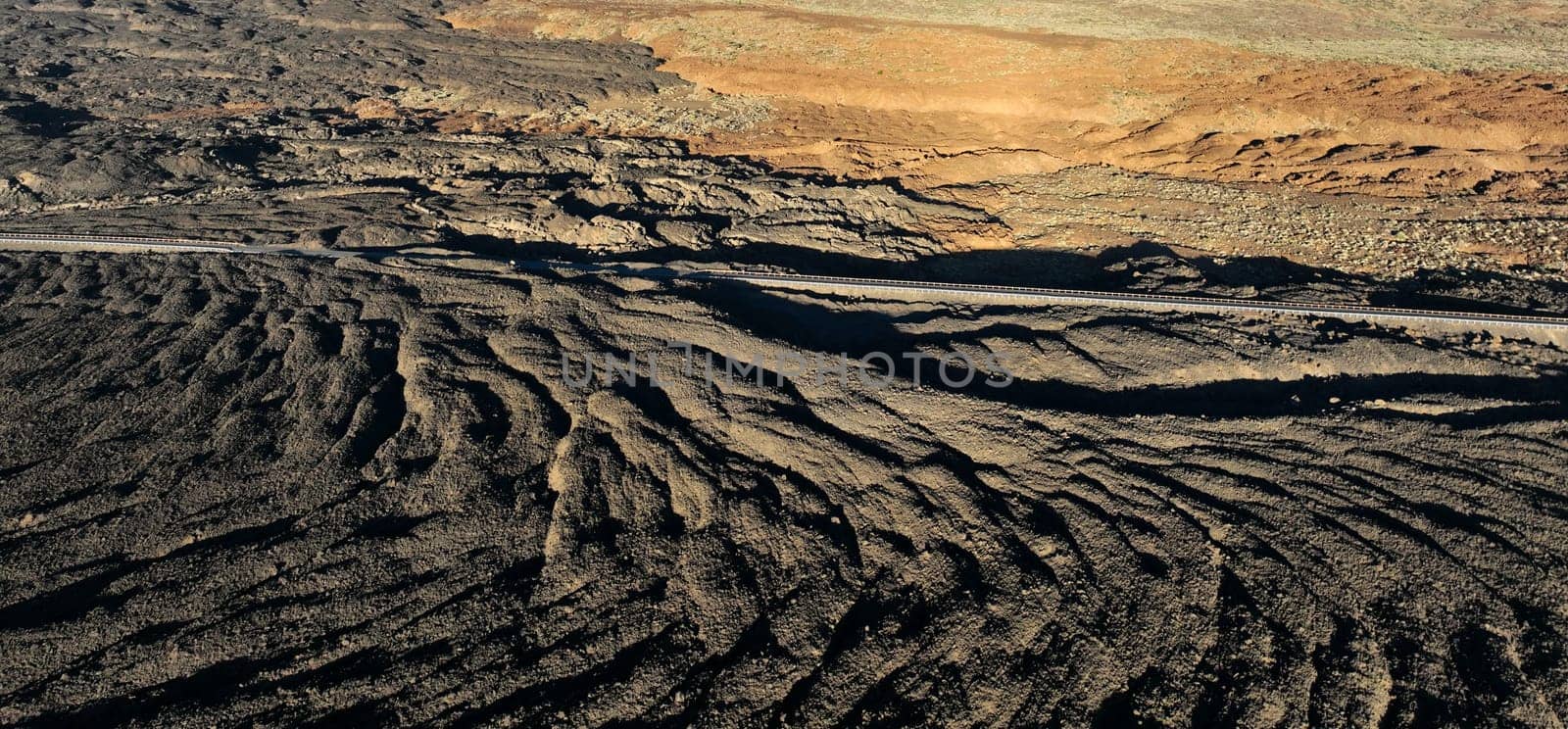 Volcanic lava formation on the islands in the sun at sunset, beautiful terrain with a volcano on the islands in the Atlantic ocean.