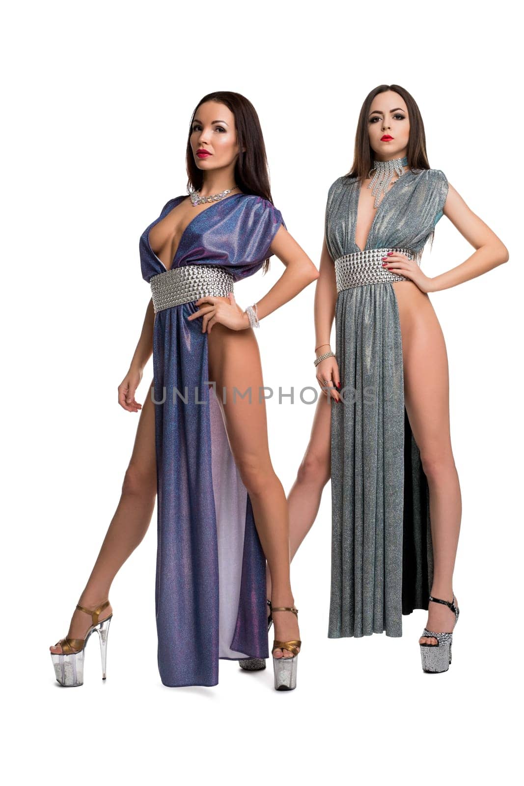 Gorgeous brunettes in sexy long blue dresses isolated full-length view on white background