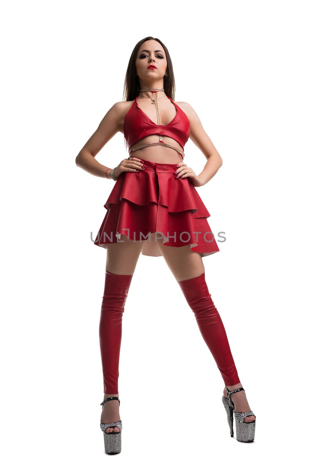 Pretty brunette in sexy red leather top and skirt full-length isolated shot on white backgound