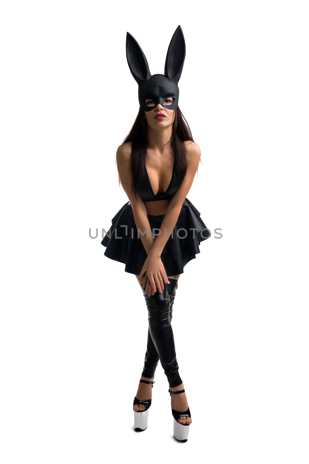 Pretty brunette in sexy black leather top and rabbit mask full-length isolated shot on white backgound