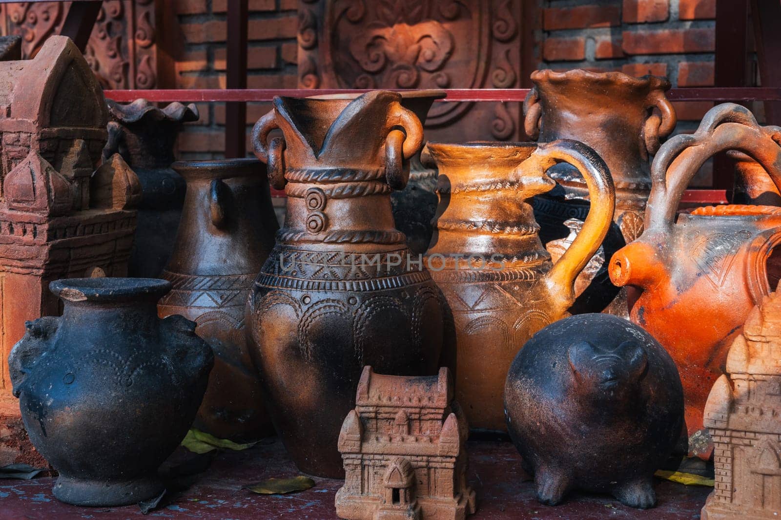 Antique clay pots, vases and jugs in a pottery workshop in Vietnam in Asia