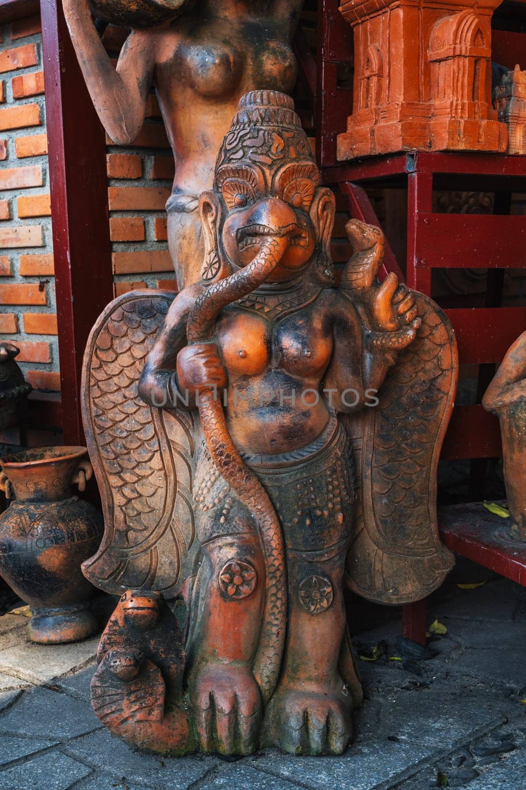 Clay Buddhist figurine statue of a deity in a souvenir shop in Vietnam in Asia