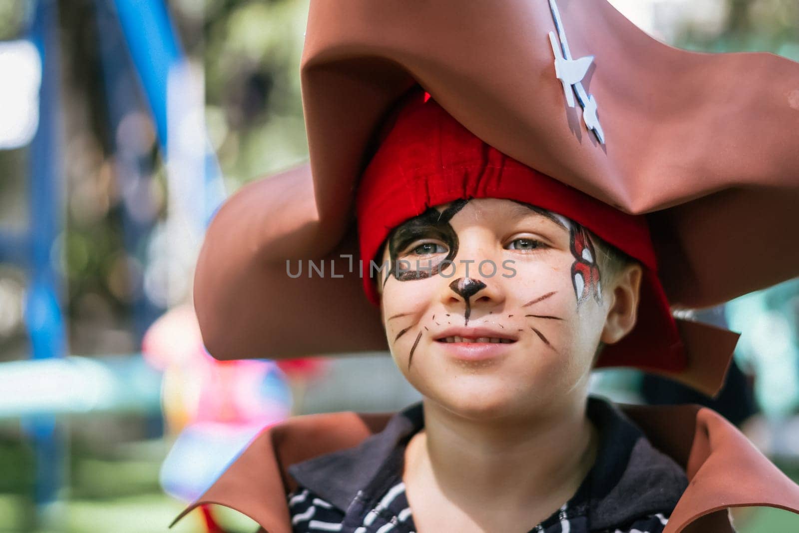 Boy Cat Pirate costume. Halloween party in kindergarten. Aqua makeup painted kids face. Bright festive.