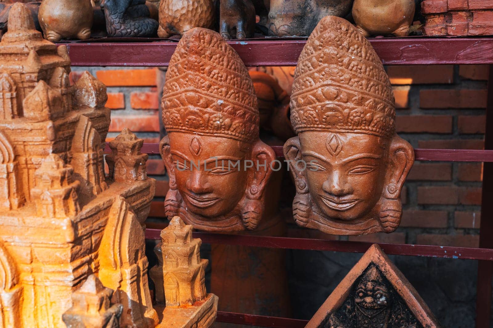 Clay Buddhist masks in a souvenir shop in Vietnam in Asia