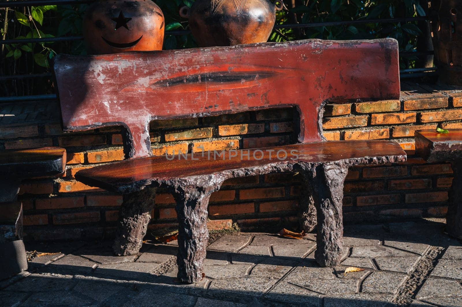 Designer brown stone bench in a park in Asia in Vietnam