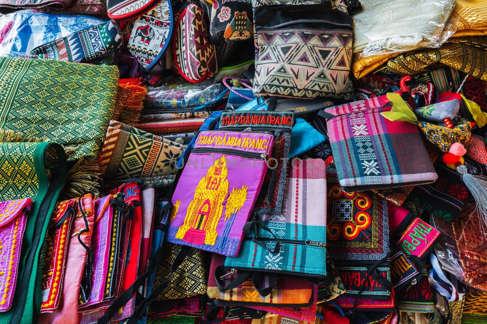 Bags and various textiles on the counter in the market in Vietnam in Asia. Nha Trang, Vietnam - August 8, 2024