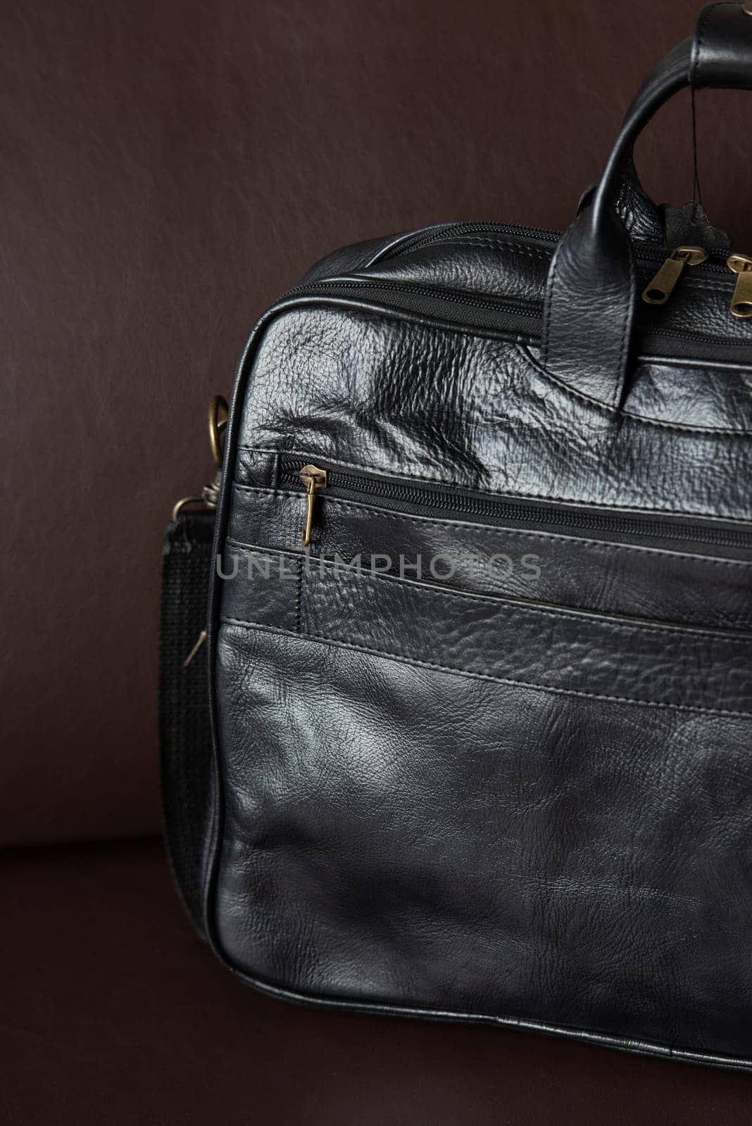 black briefcase on a brown couch