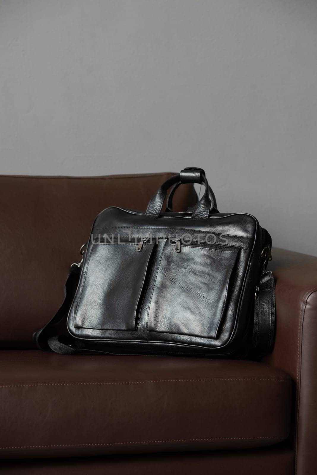 black briefcase on a brown couch