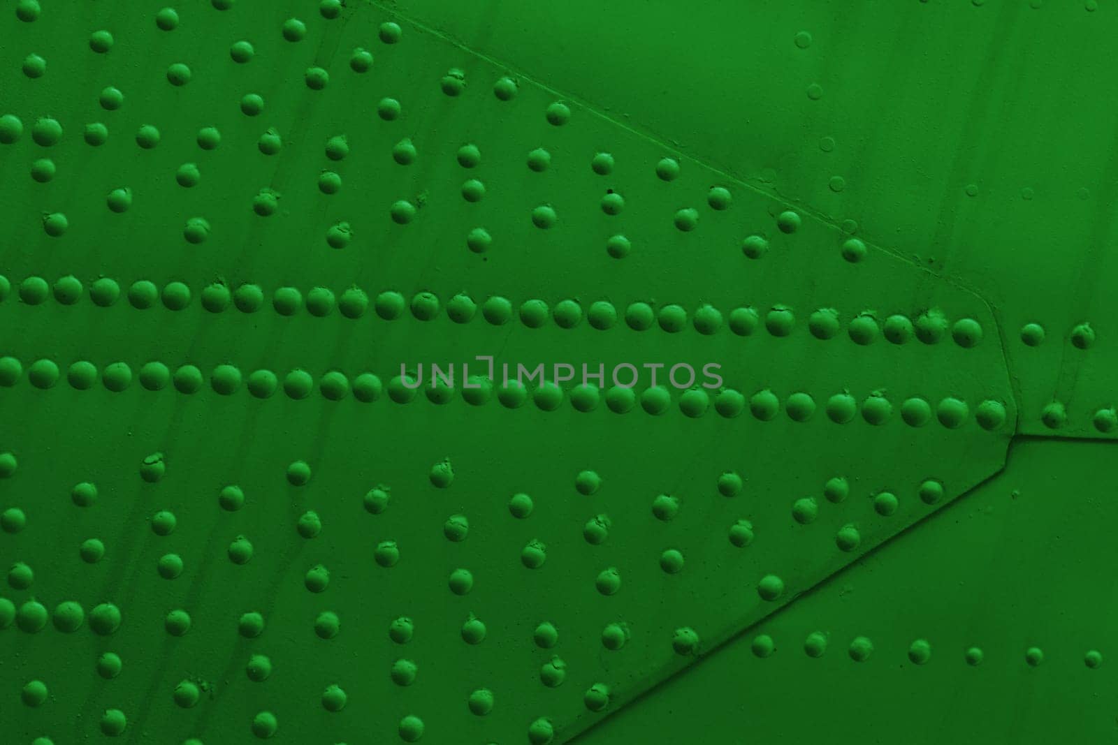 metal armor plates background. Surface of a sheet metal wall with many rivets.
