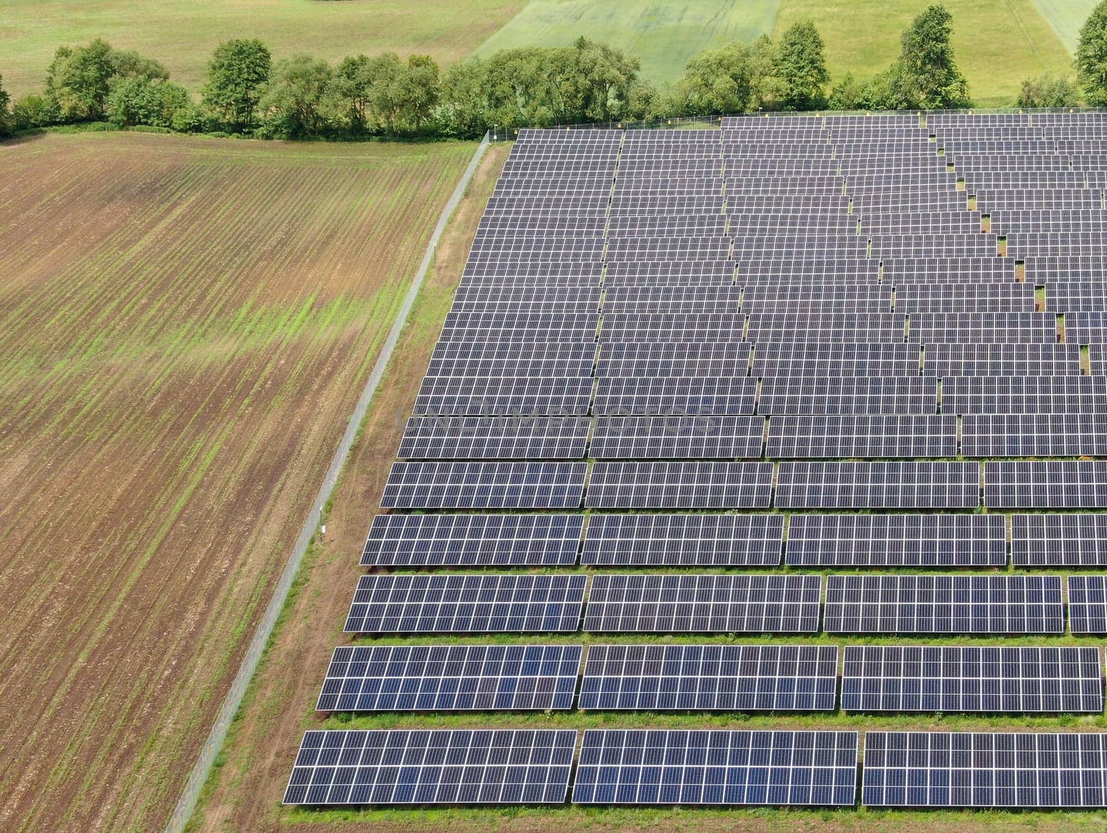 Aerial view of a solar farm. Sustainable renewable energy and modern photovoltaic technology for ecological electricity production. Green energy solutions. High quality photo