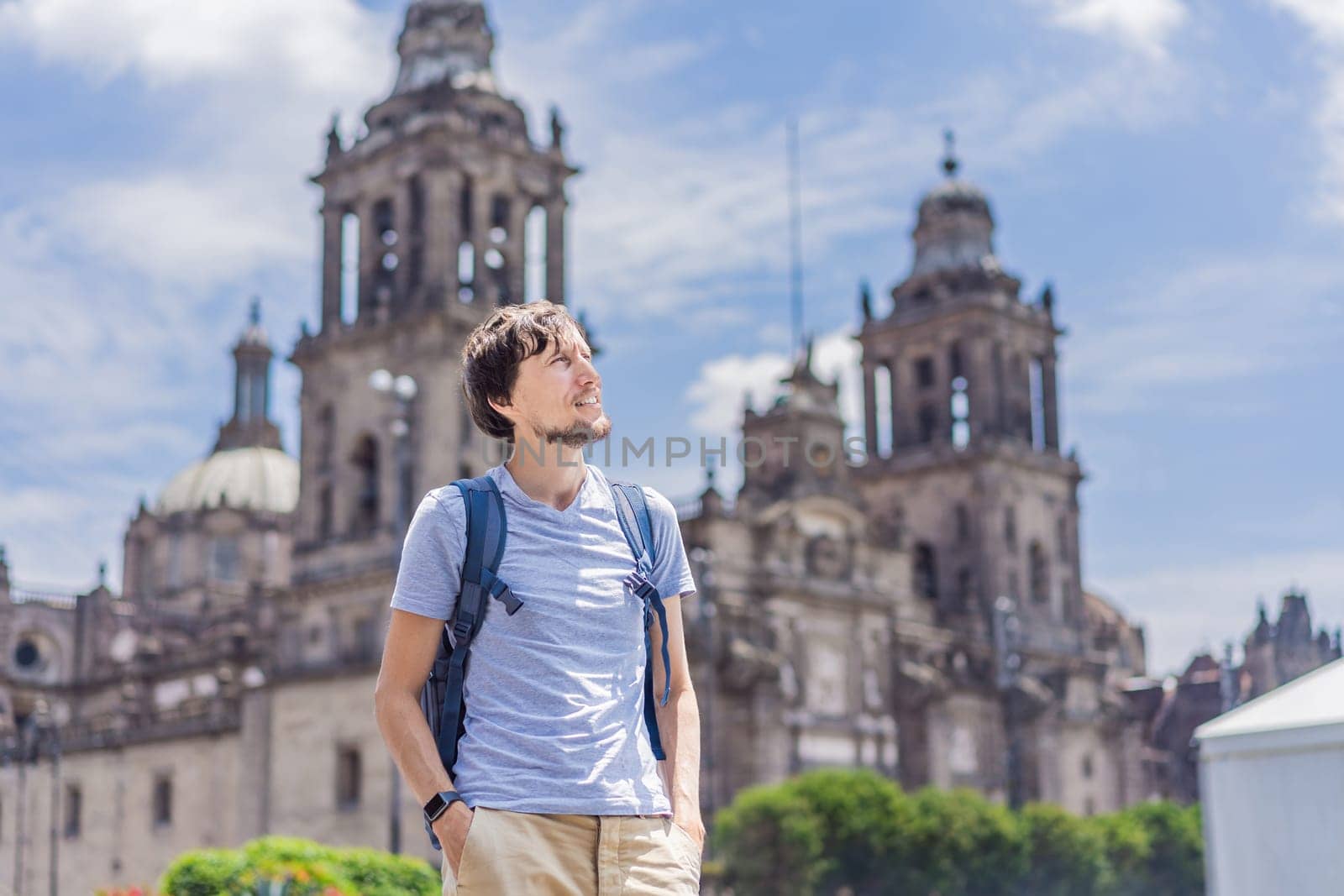 Male tourist in front of Catedral Metropolitana de la Ciudad de Mexico. Cultural exploration, historic architecture, and travel experience concept.
