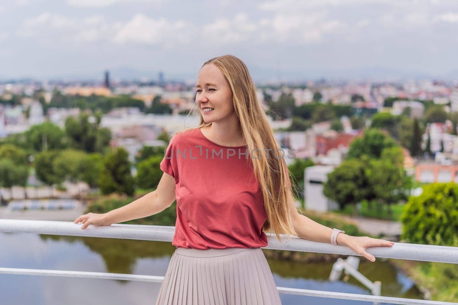 Female tourist in front of the panoramic view of Puebla city, Mexico. Travel, cultural exploration, and scenic landscape concept.