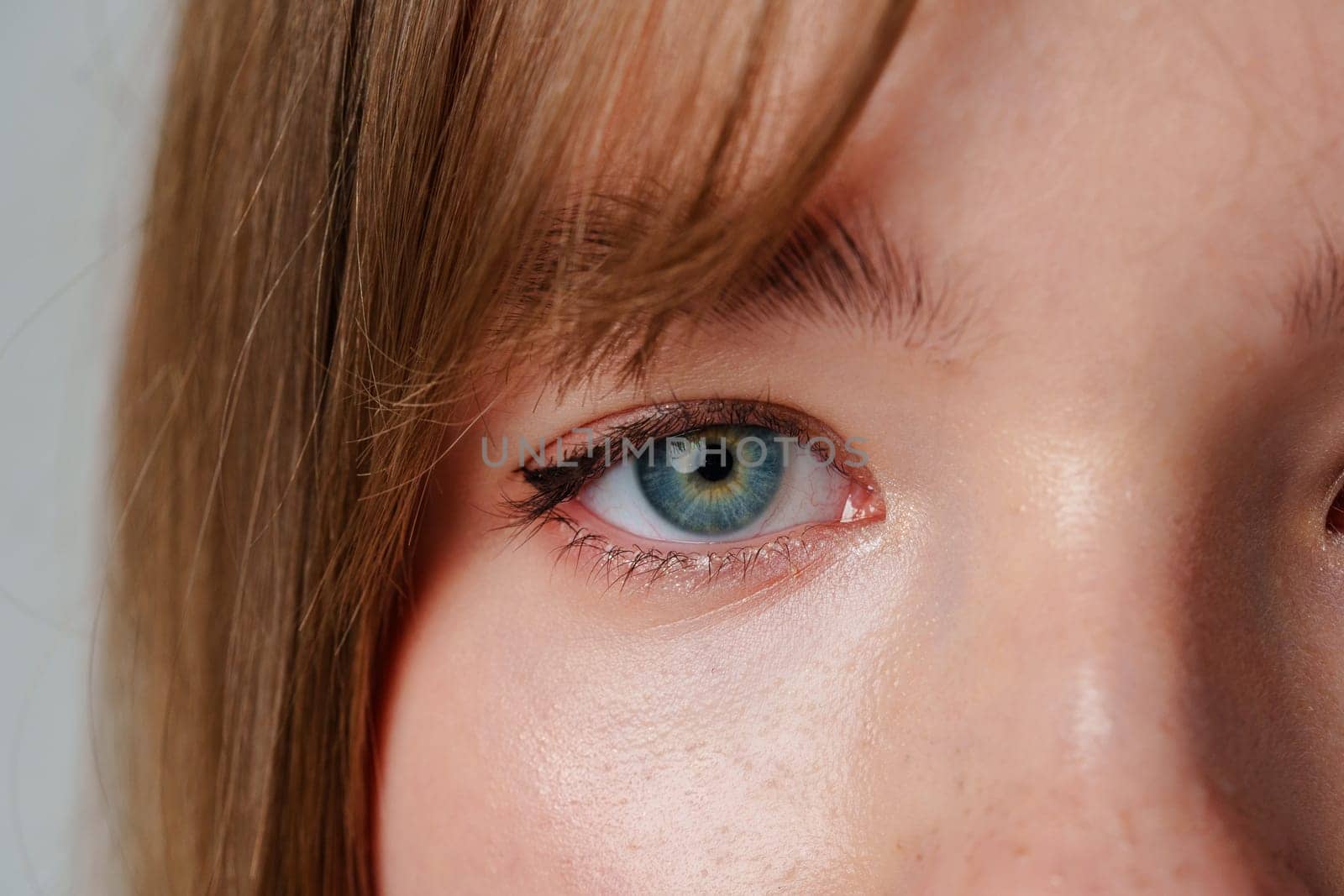 Close-up portrait of a young person with natural skin and calm expression
