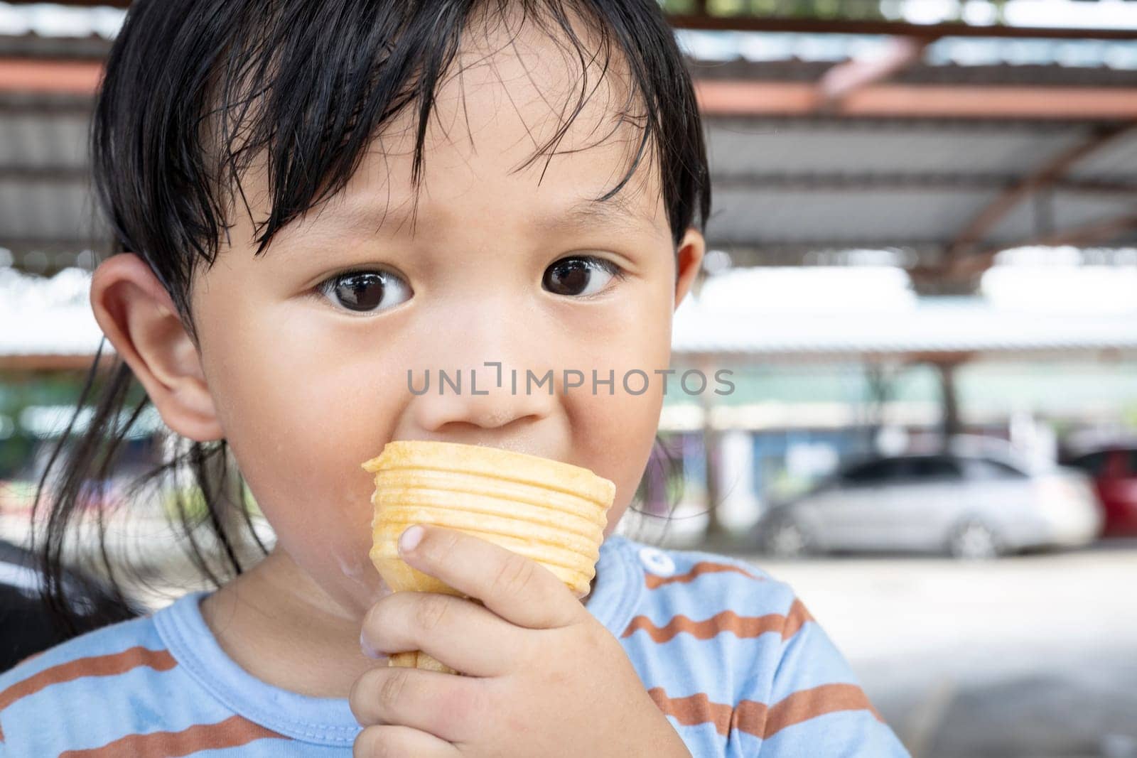 Little boy eating ice cream in the summer.