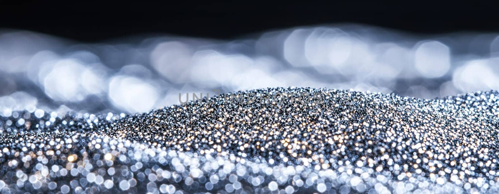 shimmering landscape of silver and gold glitter creates mesmerizing effect.